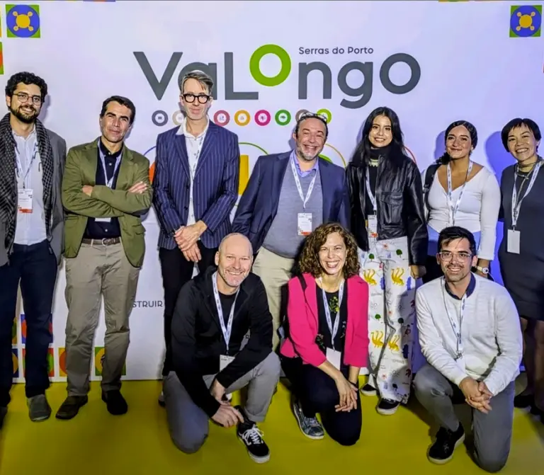 Conference attendees pose for a photo standing in two rows