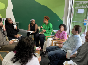 staff members sitting in a circle in chairs talking