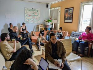 Staff chatting on couches and chairs in room